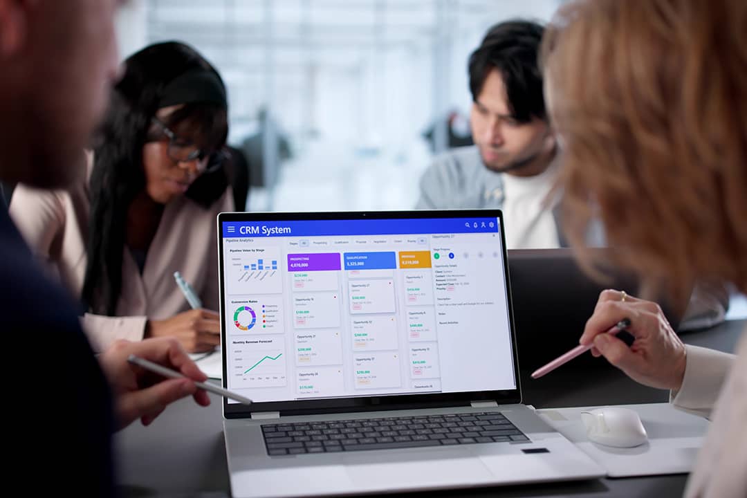 A business team using CRM software in an office.